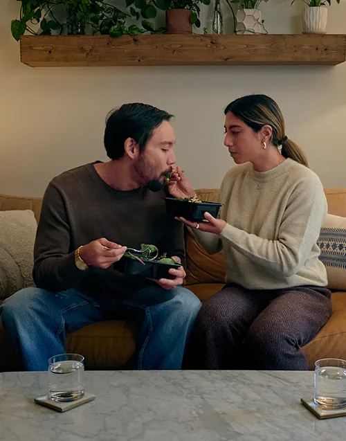 Couple eating on couch